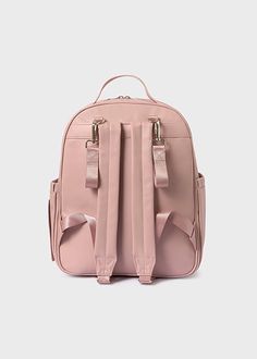 a pink backpack with two straps on the front and one strap hanging down to the side