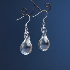 "These Clear teardrop earrings are made of glass in lampwork technique. The stainless steel hooks are hypoallergenic. They will not tarnish, fade, or discolor with time. These unique and beautiful earrings are like water drops frozen in glass! They are simple and elegant, very lightweight and comfortable to wear, perfect for everyday wear and for special occasions. You will definitely receive lots of compliments on your new earrings, everybody loves them, and you'll love them too! Dimensions: to Minimalist Teardrop Glass Jewelry, Water Drop Jewelry, Glass Drop Earrings With Matching Set, Modern Glass Teardrop Earrings, Nickel-free Glass Drop Jewelry, Glass Drop Earrings As Gift, Hypoallergenic Glass Teardrop Jewelry, Glass Teardrop Earrings With Ear Wire, Teardrop Glass Earrings With Ear Wire