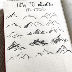 a notebook with mountains drawn on it and the words how to doodle in black ink