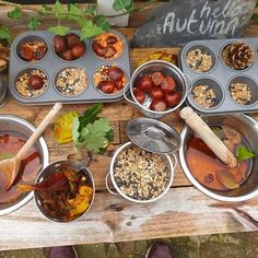 an assortment of food is being prepared on a picnic table with muffin tins