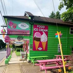 an ice cream shop is painted green and pink