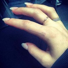 a woman's hand with two rings on it