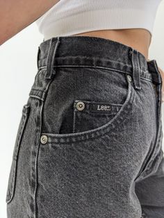 Classic vintage Lee jeans in a perfectly faded black cotton. Jeans have a high rise / tapered leg fit, belt loops along the waist, a 5-pocket design and a back waist logo patch. A lovely pair of everyday denim to wear with our James Cotton Mock Neck Sweatshirt in either heather grey or matching faded black. Pair with a cozy puffer jacket & lace-up sneakers. Tag reads Lee High Rise Gray Jeans With Belt Loops, Gray Denim Jeans With Belt Loops, Washed Black High Waist Jeans With Five Pockets, High Waist Washed Black Jeans With Five Pockets, High Waist Washed Black Jeans, Relaxed Fit Washed Black Jeans With Belt Loops, Washed Black Straight Leg Jeans With Belt Loops, Washed Black Jeans With Relaxed Fit And Belt Loops, Washed Black Denim Jeans With Belt Loops