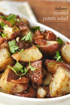 a white bowl filled with cooked potatoes and greens