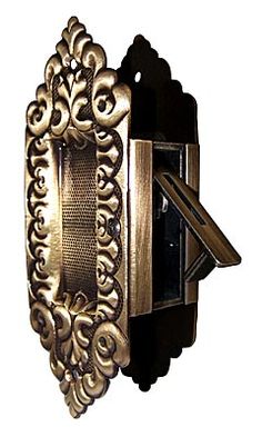 an ornately designed door handle with a key in the center and a decorative design on the outside