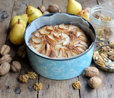 a blue dish filled with apples and walnuts