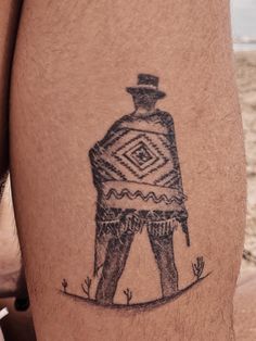 a man's leg with a drawing of a man in a hat on it