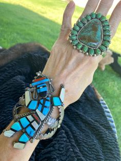 This listing is only for the cuff bracelet. The ring is available in a separate listing. Vintage Zuni Style Dancing Kachina multiple gemstone inlay Sterling cuff bracelet Cuff is 106 grams. The dancing Kachina is 4 inches tall by two inches wide, including Inlay and Silver work. The inner circumference of the cuff is around 5 1/2 inches plus a gap of 1 inch for a total wrist size of around 6 1/2 inches. If you are interested in having this cuff adjusted let me know and I will ask my jeweler. Thi Artisan Multi-stone Bangle Jewelry, Bohemian Multi-stone Bangle Jewelry, Unique Multi-stone Bangle Jewelry, Unique Multi-stone Bangle, Bohemian Multi-stone Bangle, Southwestern Multi-stone Bracelet Jewelry, Artisan Multi-stone Bracelet Jewelry, Southwestern Gemstone Bangle Jewelry, Artisan Bangle Jewelry Collectible