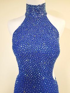 a mannequin wearing a blue halter top with silver sequins on it