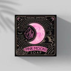 a pink moon soap sitting on top of a black box