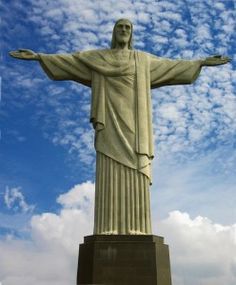 black and white photo of christ statue with clouds in the background