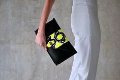 Black snake Symmetria clutch. The perfect bag for all occasions! Ideal for cocktail and parties and more. This adorable clutch is handmade out of an, Italian black cow leather and a genuine black and fluo yellow snake. It fits all your essentials, wallet, keys, mobile, cosmetics etc. It is hand stitched with black waxed thread. The interior is fully lined with dark gray leatherette. I use leatherette for the interior because it can easily be cleaned with a slightly damp sponge. The clutch closes Trendy Leather Party Clutch, Chic Yellow Clutch For Formal Occasions, Chic Yellow Rectangular Clutch, Chic Yellow Clutch As A Gift, Chic Yellow Clutch As Gift, Chic Yellow Clutch For Gift, Chic Yellow Clutch For Party, Snake Bag, Black Envelope