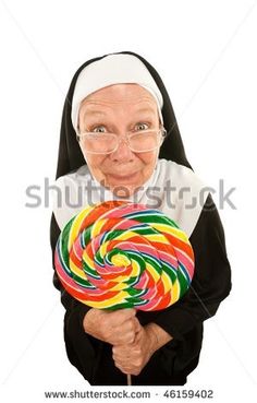 nun holding a lollipop in her hands and looking at the camera with an evil look