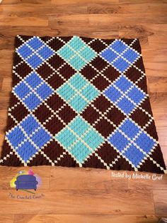 a brown and blue rug on top of a wooden floor