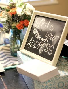 an image of a chalkboard with writing on it next to a vase full of flowers