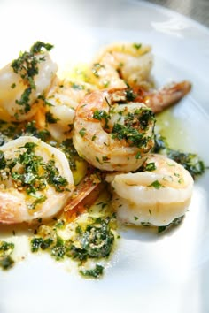 a white plate topped with shrimp and broccoli