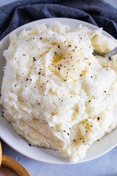 mashed potatoes on a white plate with a spoon