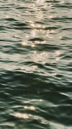 the sun shines brightly on the water as it reflects off the surface of the ocean