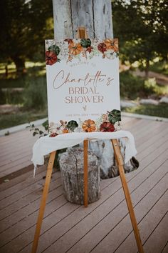 a sign that says charlotte's bridal shower sitting on top of a wooden table