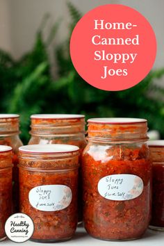 jars filled with homemade canned sloppy joes sitting on a table