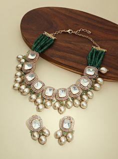 Gold Tone Kundan Polki Biege Necklace Set - Joules By Radhika This designer handcrafted necklace & earring set is made with far size polkis with biege pearl drops & beaded with green agates. The amalgamation of colours by the designer gives it a very classy look making it ideal to be worn on festive, wedding & party occassions on your Indian & fusion attire. Every artistic piece from Joules by Radhika is made with real semi precious stones only, giving it a regal look & feel. Necklace has adjust Luxury Pista Green Kundan Sets, Festive Handmade Pearl Kundan Necklace, Festive Green Pearl Drop Necklace, Green Kundan Necklace With Polished Beads, Green Meenakari Pearl Necklace For Celebration, Festive Green Kundan Necklace With Dangling Beads, Elegant Green Kundan Necklace With Dangling Beads, Green Jewelry With Gota Work For Celebration, Festive Green Pearl Necklace With Polished Beads