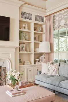 a living room filled with furniture and a fire place