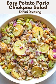 a white bowl filled with chickpea salad on top of a table