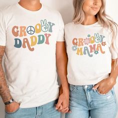 two people standing next to each other wearing t - shirts that say grooy daddy and groo mama