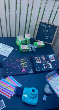 a blue table topped with lots of different types of papers and items on top of it