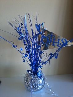 a vase filled with blue and silver decorations