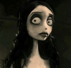 a creepy doll with big eyes and long hair