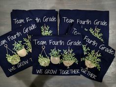 four embroidered tea towels with green plants on them and the words team fourth grade written in white