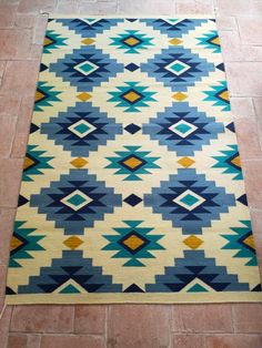 a blue and yellow rug on the floor