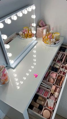 a vanity with lights and cosmetics on it