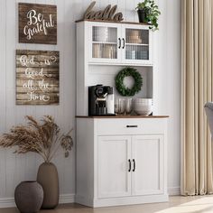 a white hutch sitting in the corner of a room