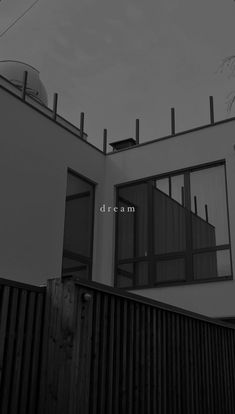 a black and white photo of a house with the word dream written in front of it