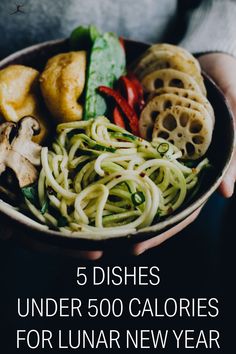 a person holding a bowl filled with different types of food and text that reads, 5 dishes under 500 calories for lunar new year