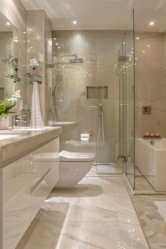 a bathroom with a toilet, sink and bathtub next to a walk in shower