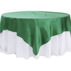 a green and white table cloth on top of a round table