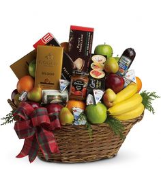 a basket filled with assorted fruit and chocolates