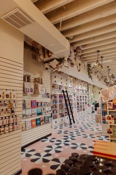 the inside of a store with lots of shelves and decorations on the walls, along with bookshelves