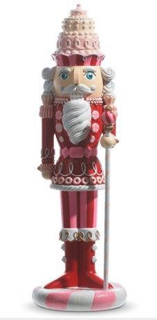 a red and white nutcracker figurine with a cane in its hand