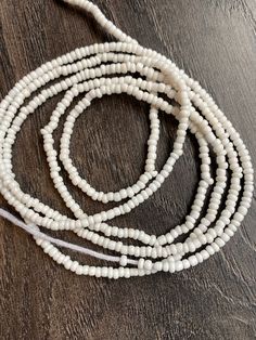 These beads come in 3 piece and are tie ons, they are 45"- 52" long and self adjustable based on your waist size. ★ Please note, the Bead option you pick is exactly what you'll receive. ★ The listed prices are for one strand each. For multiple strands you'll have to indicate from the quantity section in your cart. ﻿★★★★ ALL SALES ARE FINAL. THERE ARE NO EXCHANGES OR RETURNS★★★★ Uses of Waist beads ★ Cultural and Spiritual Reasons ★Waist beads as ornaments as well as for symbolic adornment, ★ whi Adjustable White Waist Beads With Tiny Beads, Adjustable White Bohemian Waist Beads, Adjustable White Waist Beads With Spacer Beads, Adjustable White Waist Beads For Festival, Adjustable White Beaded Lariat Necklace, White Adjustable Lariat Beaded Necklace, White Waist Beads, Waist Beads, Waist Size