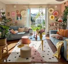 a living room filled with furniture and lots of plants