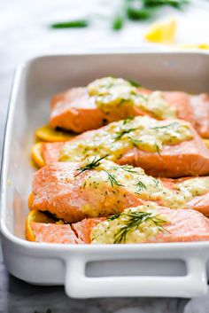 salmon with lemon and dill sauce in a white casserole dish