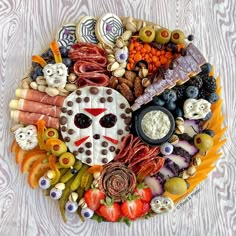 a platter filled with different types of food on top of a white tablecloth