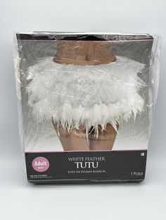 a white feathered hat in a plastic box