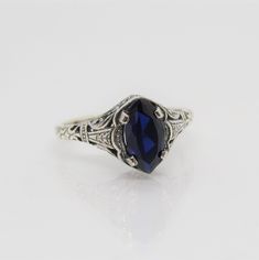 Sterling Silver Blue Sapphire Filigree Ring ....Marked 925...Total of weights 2.1grams..Size 10...Measure of Face 10.1MM...It's in very good condition. Mens Blue Topaz Rings, Sterling Silver Sapphire Filigree Ring Gift, Antique Sapphire Ring In Blue, Vintage Blue Oval Sapphire Ring, Heirloom Blue Sapphire Ring Hallmarked, Blue Engraved Sterling Silver Rings, Engraved Blue Sterling Silver Rings, Collectible Blue Rings, Collectible Blue Sapphire Ring Hallmarked