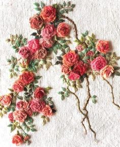 an embroidered piece of cloth with flowers on it