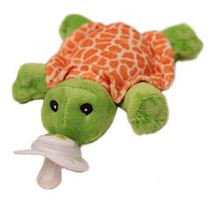 a stuffed animal turtle with a pacifier in its mouth and an orange giraffe pattern on it's shell